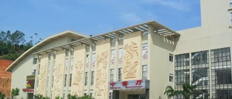 A building with a large entrance and multiple windows.