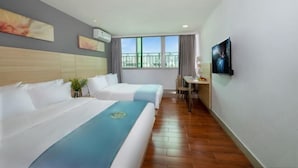 A hotel room with two beds, a desk, a chair, and a large window with a balcony view. - Shenzhen Lanyu Hotel (Dongmen Old Street) (Shenzhen)