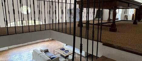 A spacious living area with a staircase, a white sofa, and a coffee table.
