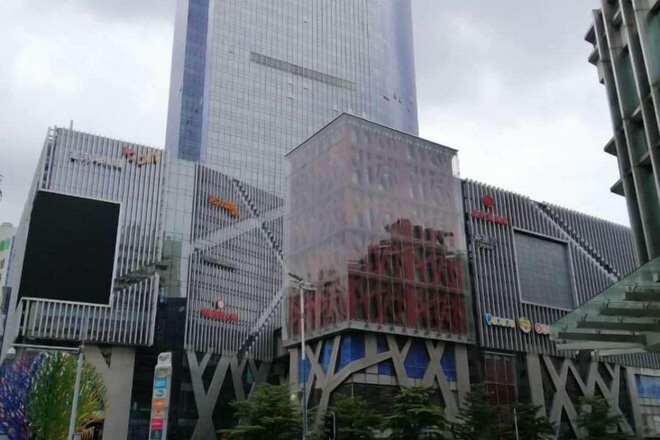 A modern building with a glass facade and a prominent 'XX' logo.
