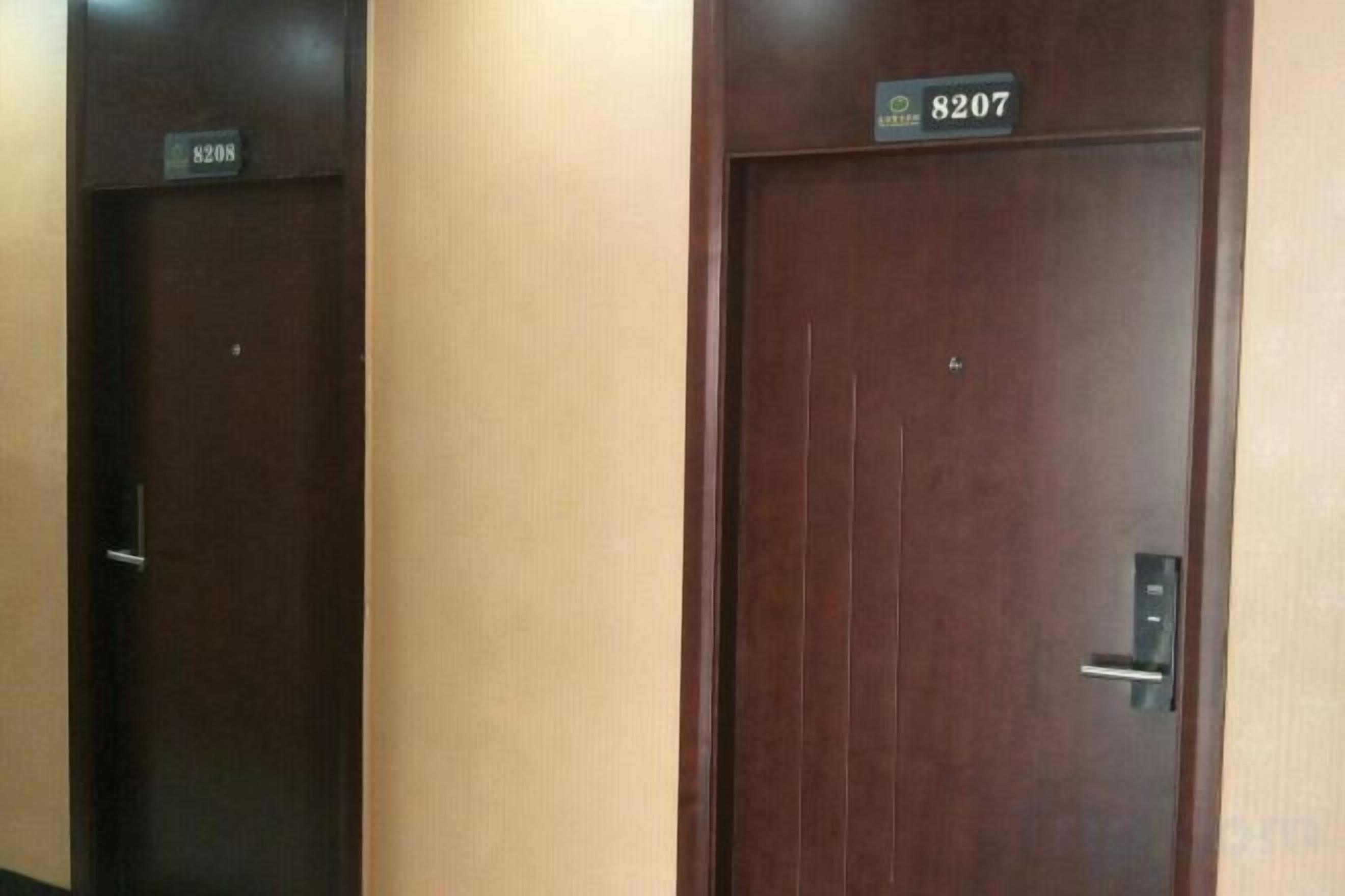 Two wooden doors with numbers 8208 and 8207, likely indicating hotel room numbers.