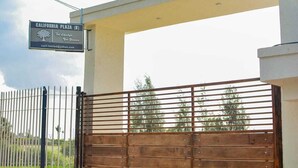 A gated entrance with a sign for California Plaza (K). - Nanyuki One Bedroom Apartment (Nanyuki)
