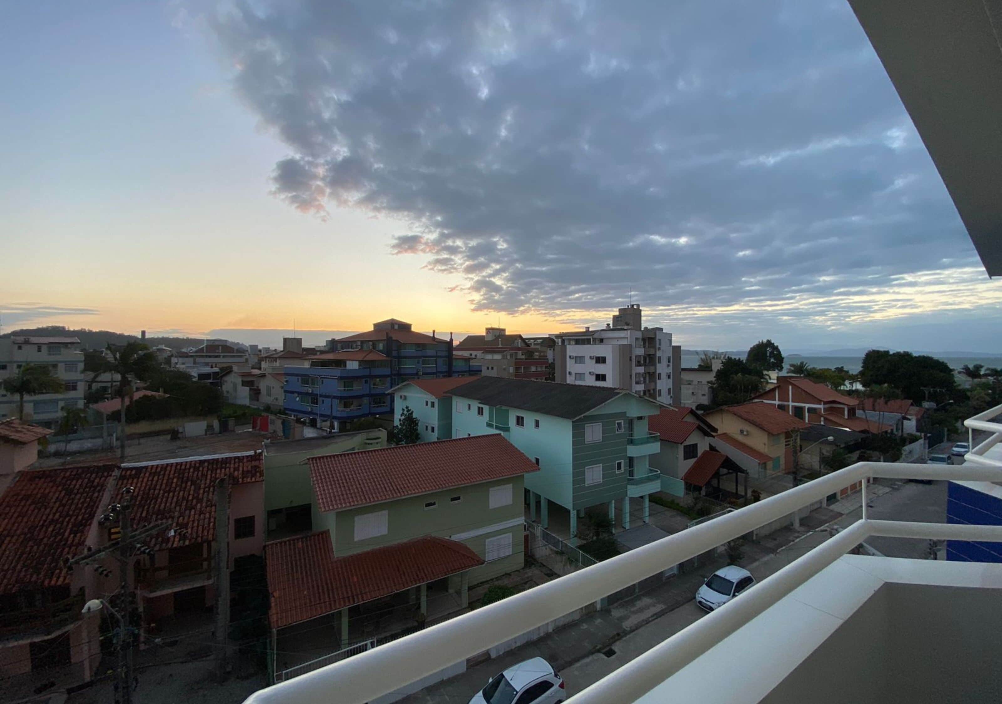 Un barrio residencial con diversos edificios, incluyendo casas y complejos de apartamentos, bajo un cielo nublado.