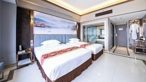 A modern hotel room with two beds, a large window, and a view of a snowy landscape. - Sanshui Sunshine Holiday Hotel (Foshan)