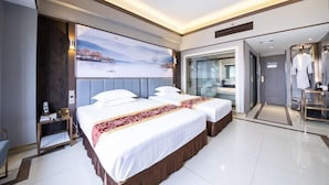 A modern hotel room with two beds, a large window, and a view of a snowy landscape. - Sanshui Sunshine Holiday Hotel (Foshan)