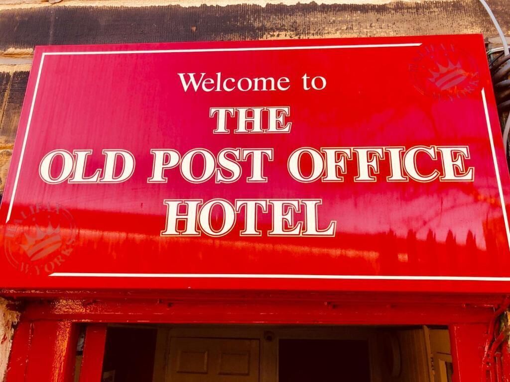 A red sign for The Old Post Office Hotel.