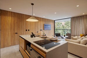 Relax in this open-plan living space with an induction cooktop and comfortable seating area.