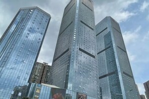 A cluster of high-rise buildings with reflective glass facades, likely part of a business district. - Kunming Panlong Days Inn Selected Wyndham Hotel (Agricultural University Branch) (Kunming)