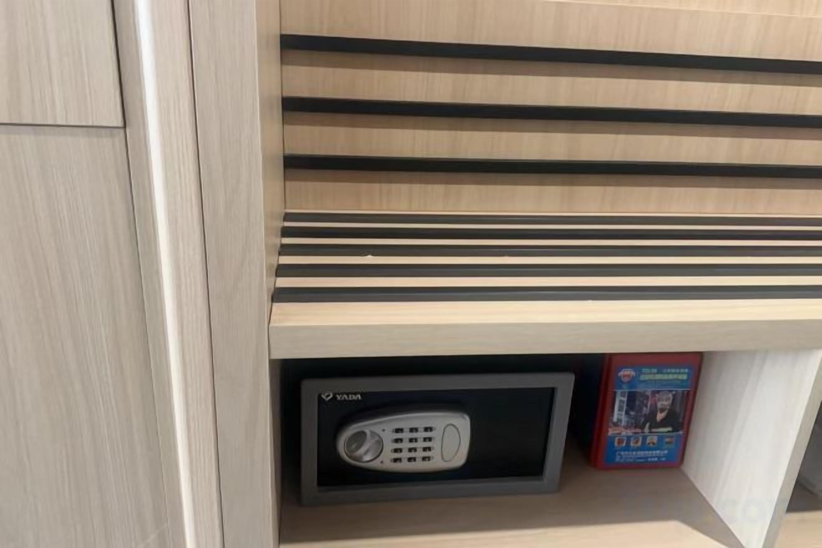 A wooden shelf with a built-in radio and a book.