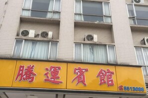 A hotel sign with Chinese characters and a phone number.