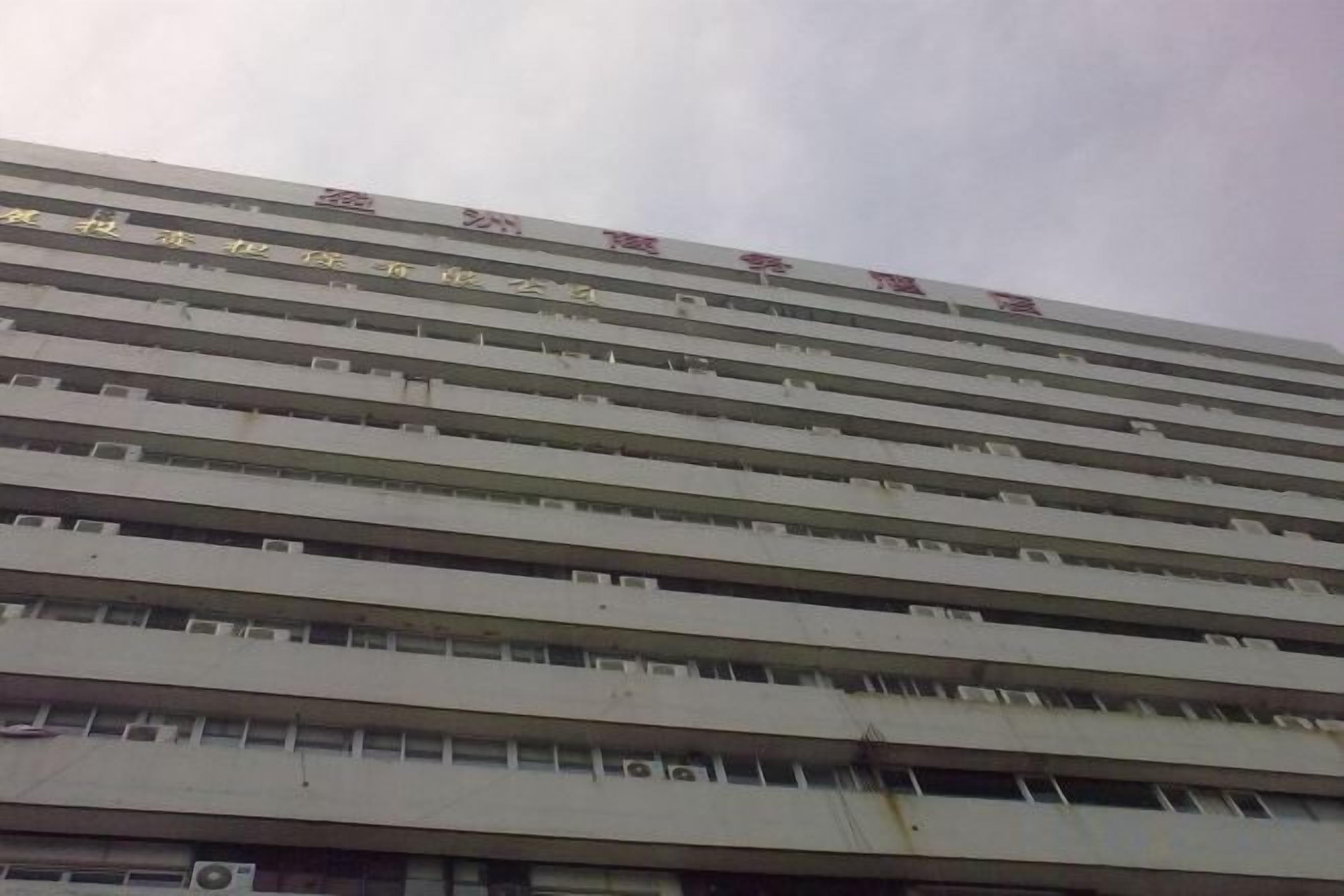 A multi-story building with a flat facade and evenly spaced windows.
