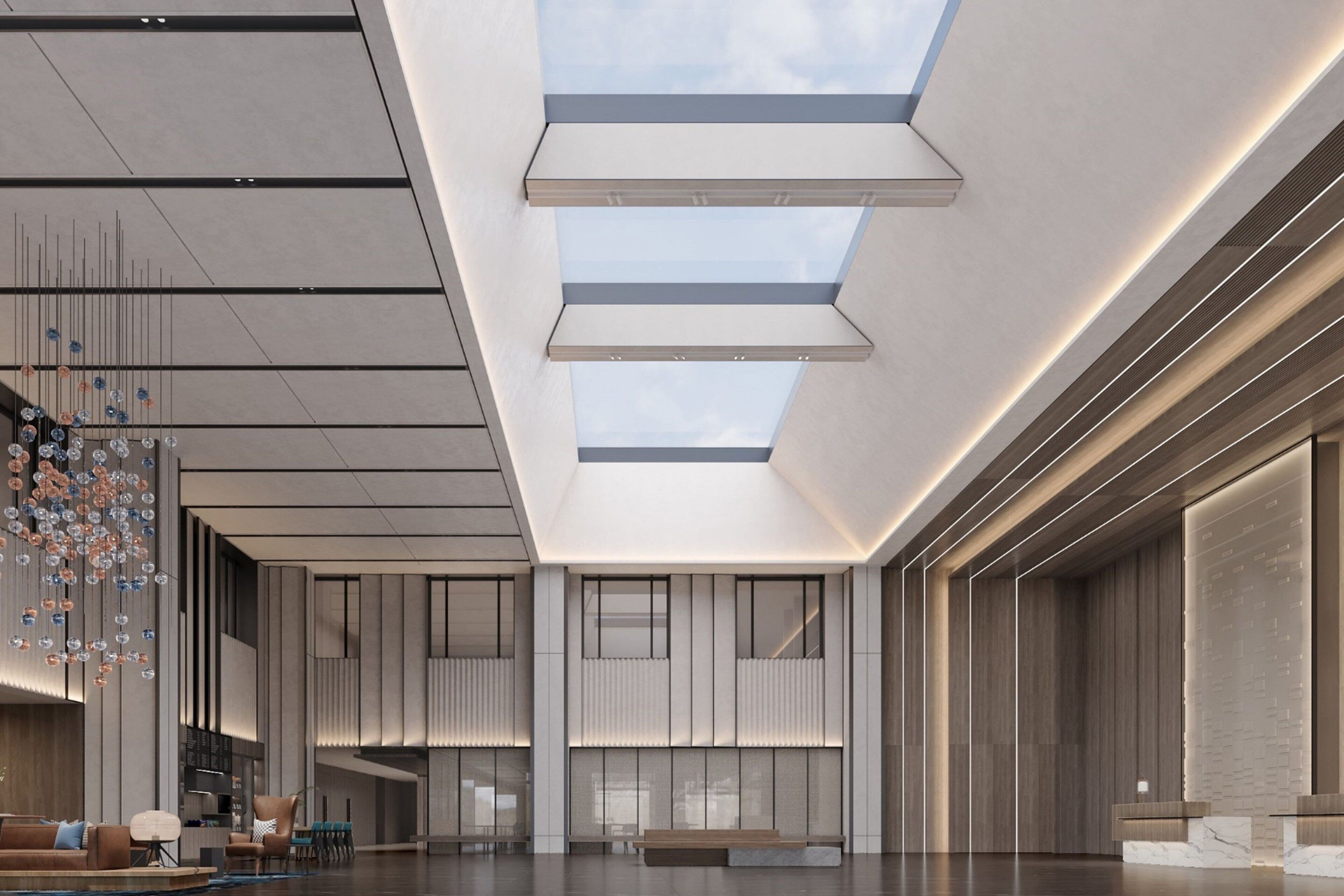 A spacious lobby with a high ceiling, skylights, and a modern reception desk.
