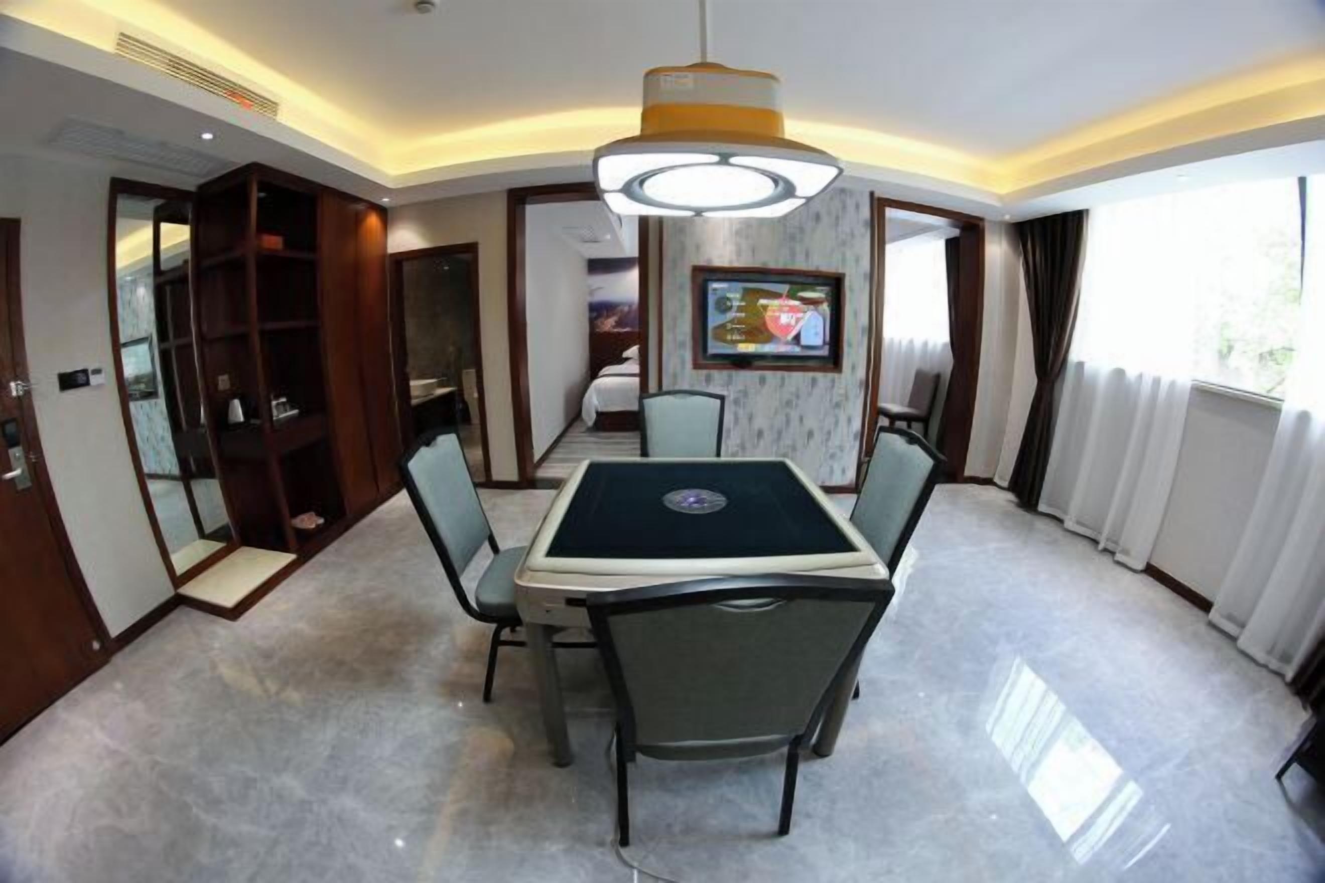A conference room with a table, chairs, a television, and a large window.