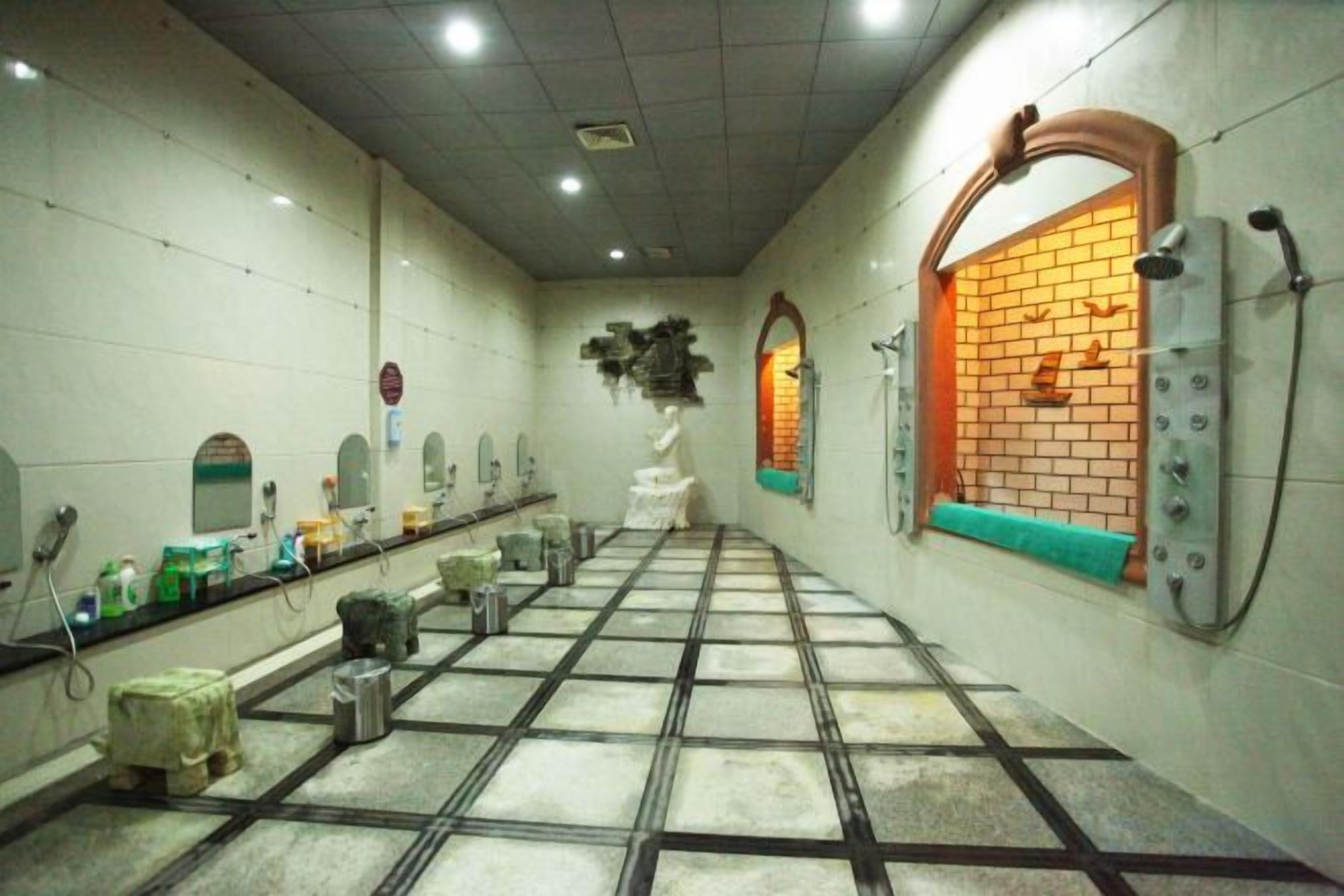 A public restroom with multiple sinks, mirrors, and a tiled floor.
