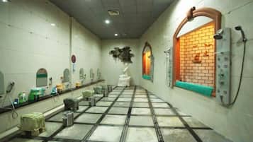 A public restroom with multiple sinks, mirrors, and a tiled floor.