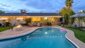 A backyard with a swimming pool, outdoor seating, and a fire pit. - Old Town 4BR Gem | Pool, Firepit, WiFi, & Games! (Scottsdale)