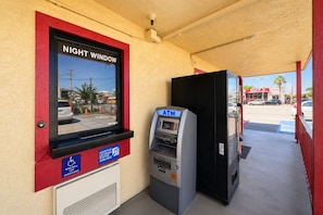 An ATM machine, a night window, and a sign indicating an assistive listening system. - Century Motel Buena Park Disneyland (Buena Park)