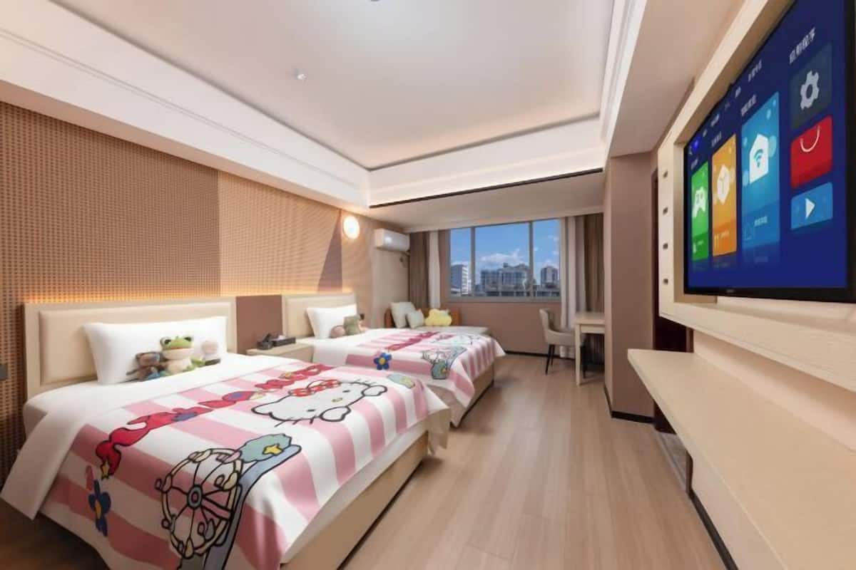 A hotel room with two beds, a large TV, and a city view.