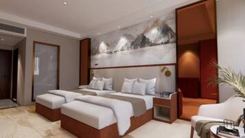 A modern hotel room with a large bed, two bedside tables, a seating area, and a large abstract painting on the wall.
