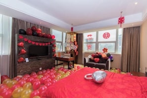 A room with a fireplace, a bed, a TV, and a window with curtains. - Meister Hotel (Chongqing)