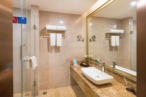 A modern bathroom with a glass shower enclosure, a marble countertop, and a large mirror. - Meister Hotel (Chongqing)
