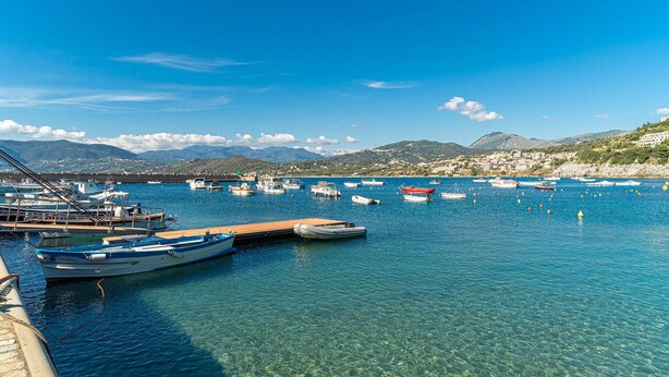 A marina with boats docked, clear blue water, and a mountainous backdrop. - Gorgeous home in Ascea Marina with house sea view (Ascea Marina)
