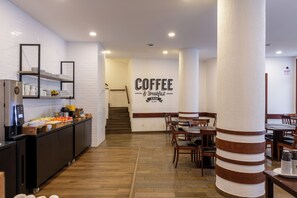 A modern coffee and breakfast area with a sign, wooden flooring, and a buffet setup. - DELPLAZA Timbiras São Paulo (São Paulo)