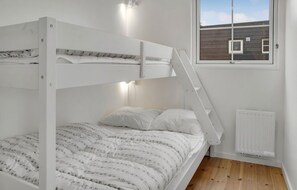 Cozy bedroom with a bunk bed setup featuring a ladder for easy access.