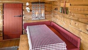 A cozy cabin interior with a checkered table, a red door, and a patterned wall hanging. - Cozy home in Vinstra with kitchen (Vinstra)
