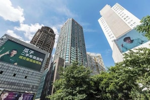 A cityscape with tall buildings, one featuring a prominent advertisement. - Jufuyuan Apartment (Shenzhen)