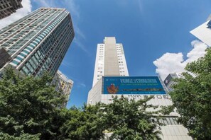 A high-rise building with a prominent advertisement on its facade. - Jufuyuan Apartment (Shenzhen)