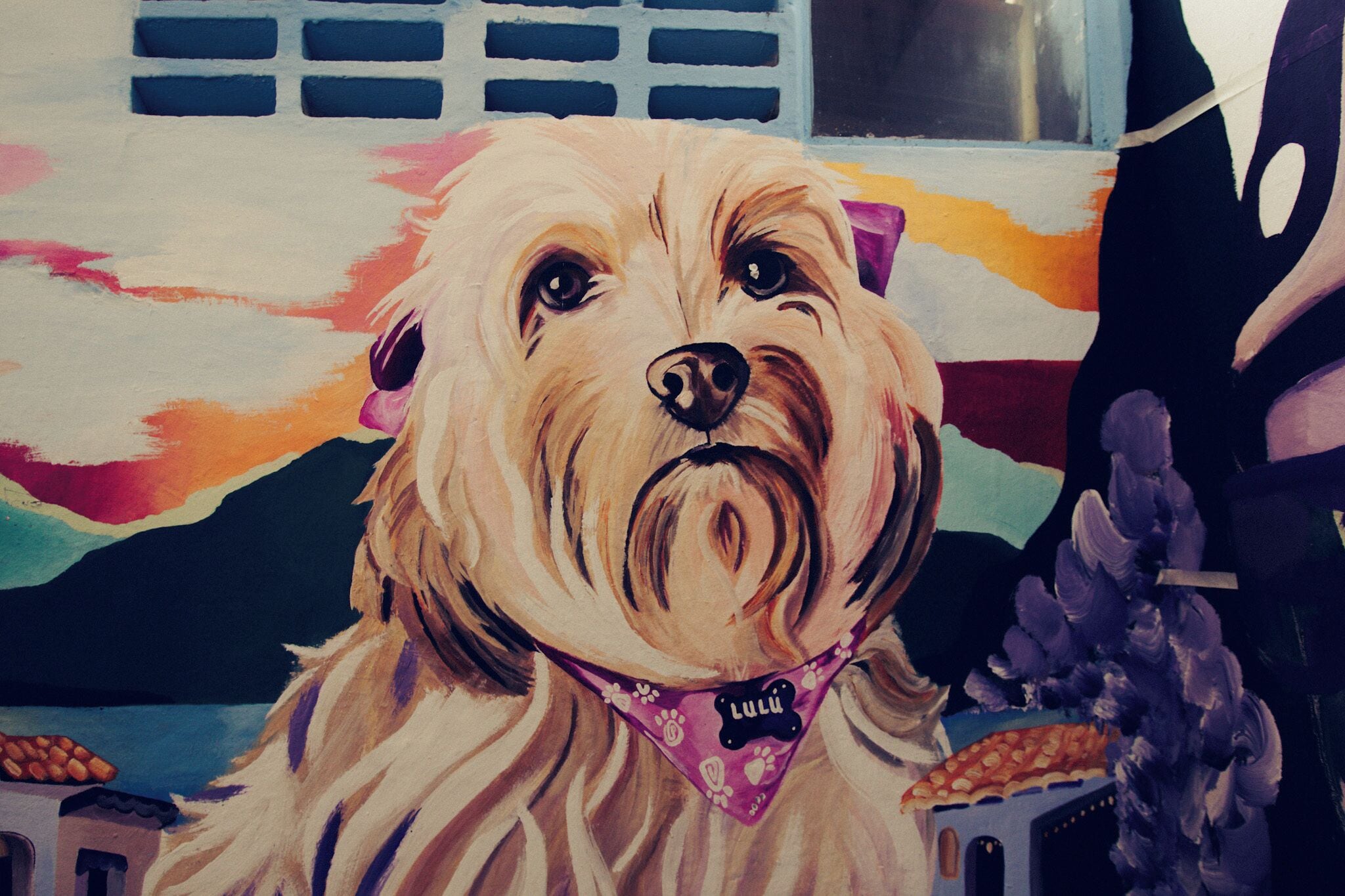 A painting of a dog with a bandana.