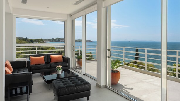A spacious balcony with a view of the sea and hills. - Beachfront Elegance with Spectacular Sea Views in Kavouri Vouliagmeni  (Vouliagmeni)