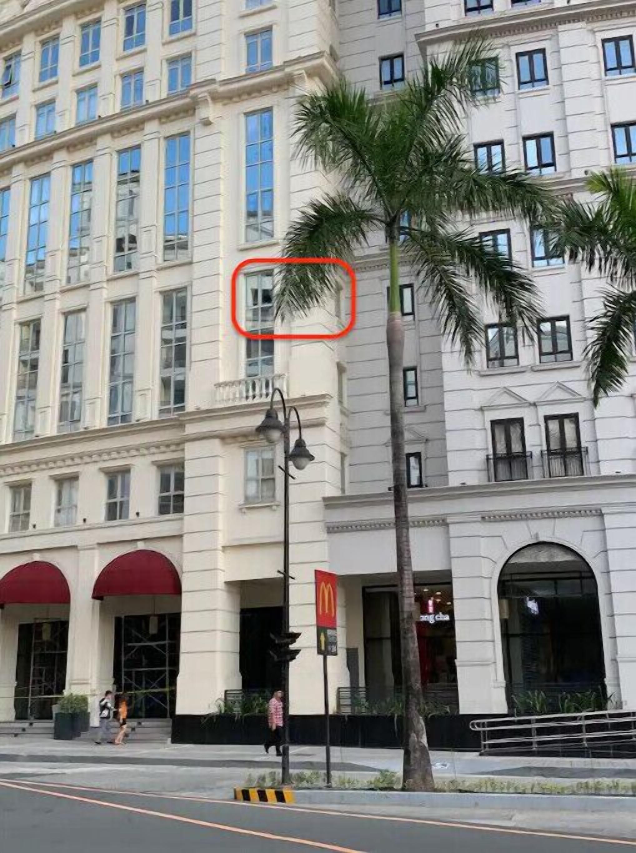 A multi-story hotel with a classic architectural style, featuring large windows and a red awning.