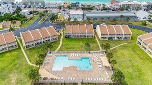 A resort with a central pool, multiple buildings, and a view of the ocean. - 10D, The Beach Nest (Destin)