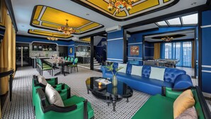 A modern hotel lobby with a dining area, a sofa set, and a chandelier. - Indochine‑Style Private Pool Villa Full Bay View |5 BR | Karaoke • Billiards (Thành phố Hạ Long)
