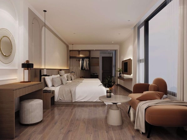 Une chambre d’hôtel moderne dotée d’un grand lit, d’un coin salon avec un canapé, d’une petite table ronde et d’une grande fenêtre.
