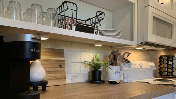 A modern kitchen with a Keurig coffee maker, a potted plant, and a white mug on the counter. - CHARMING...COMFORTABLE...CONVENIENT (Denton)