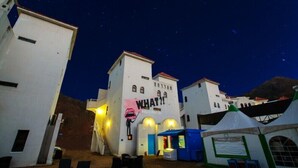 A building with a sign reading "WHAT?" and a tent in the foreground. - Fapas Pension (Chuncheon)