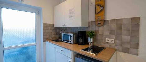 Fridge, microwave, stovetop, coffee/tea maker