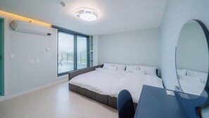 A modern bedroom with a large bed, a desk, and a large mirror. - My Kids Pool Villa (Taean)