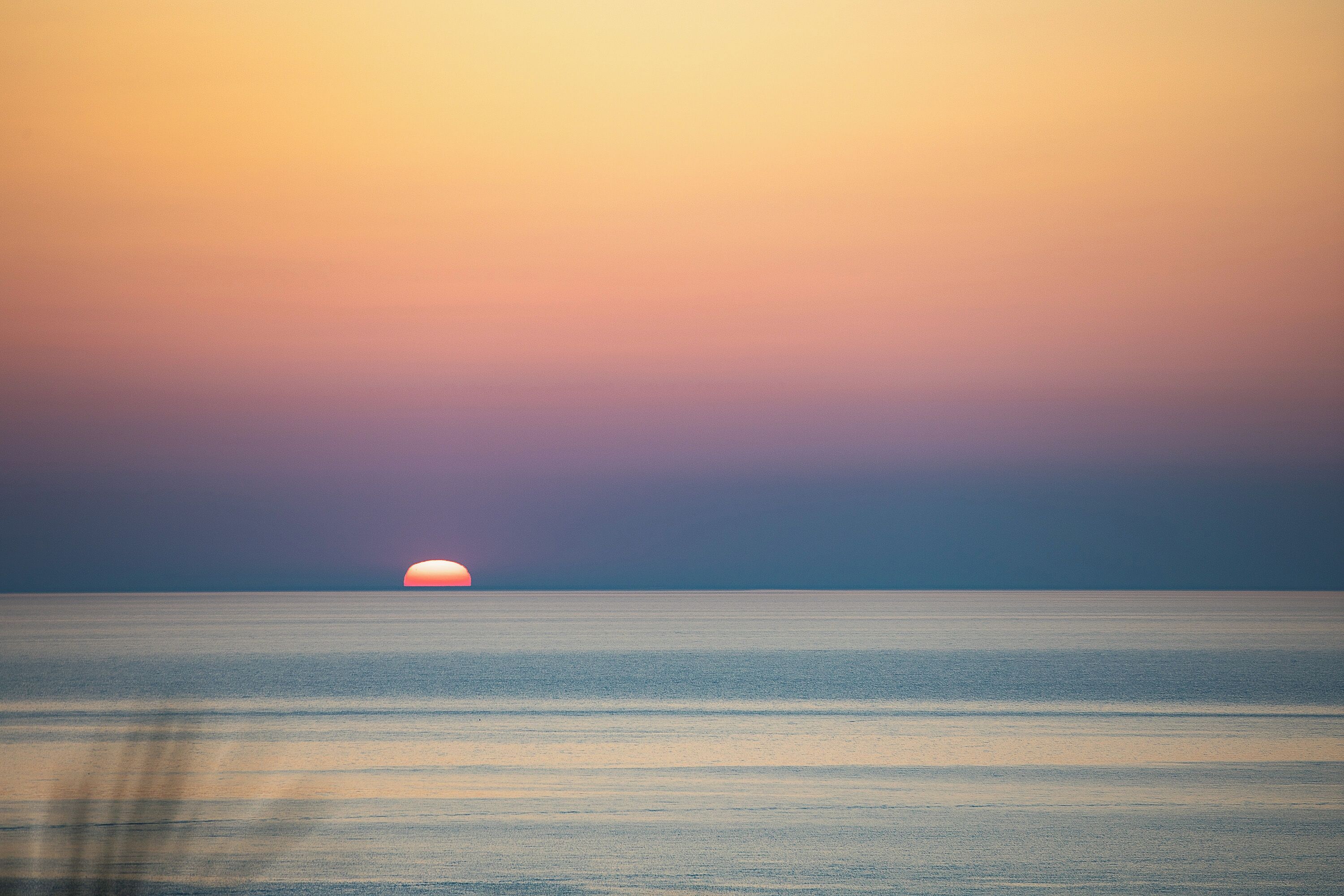 A calm sea with a sunset.