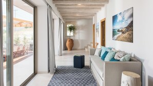 A modern living room with a sofa, a coffee table, and a large window. - Villa Elpida Sea view & heated* pool! (Kissamos)