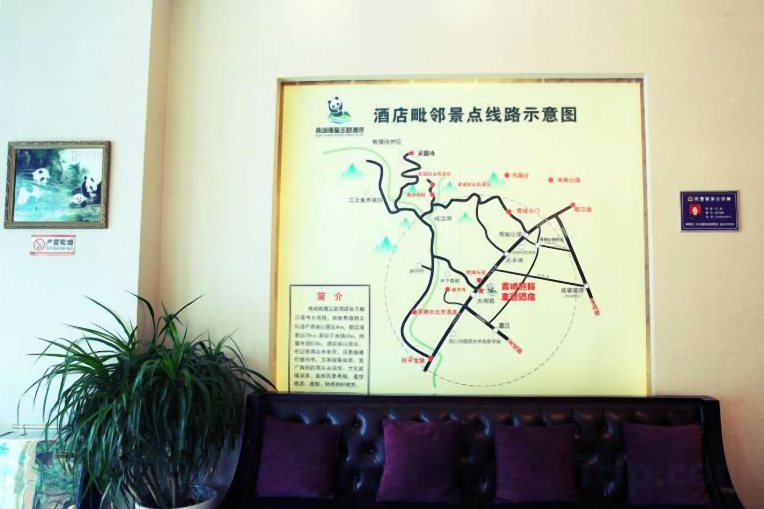 A framed map on a wall with a potted plant beside it.