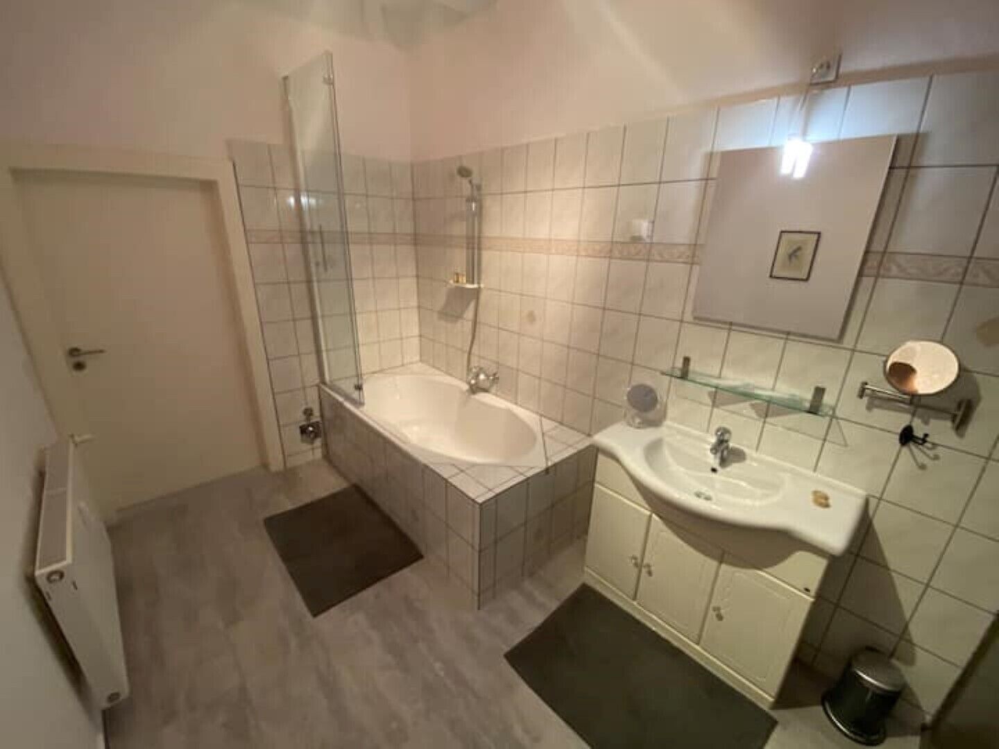 A bathroom with a bathtub, a sink, and a shower.