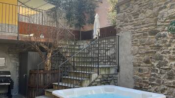 Relax in an outdoor space with a hot tub, barbecue grill, and scenic views.
