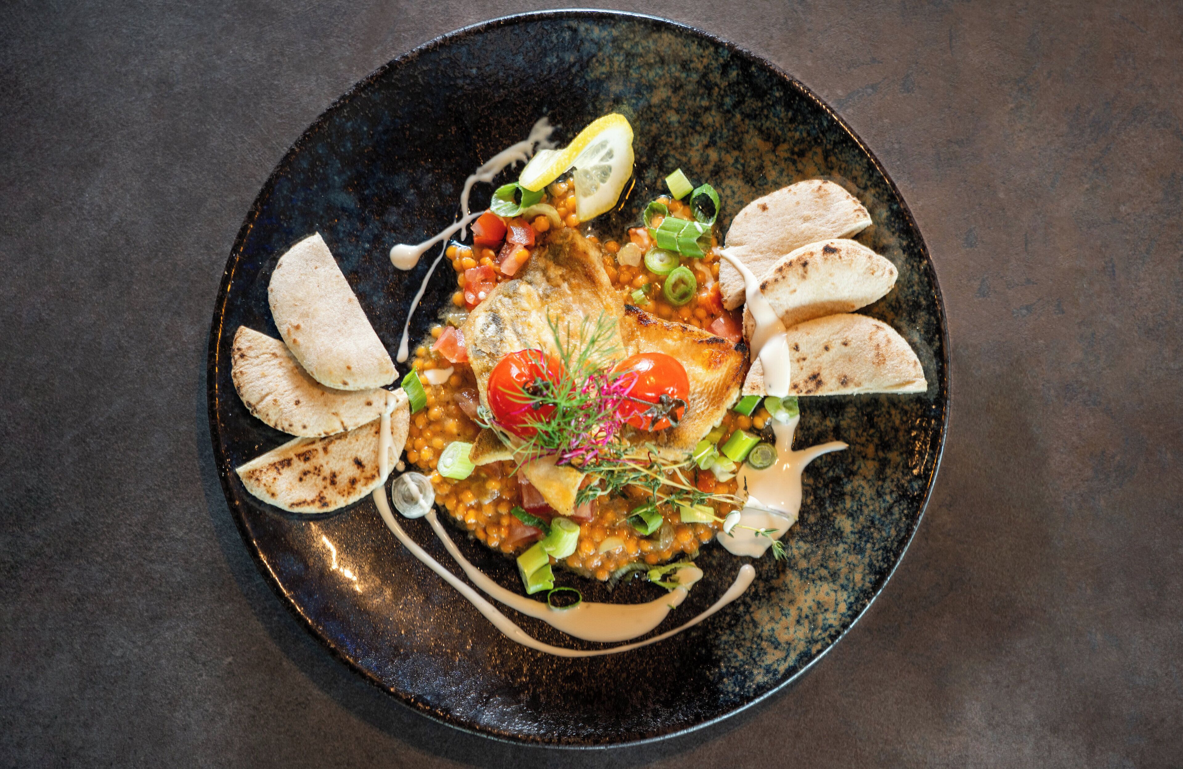 A plate of food with various toppings and garnishes.