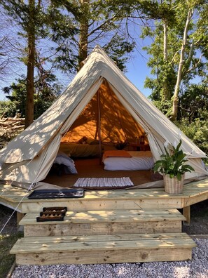A triangular tent with a bed inside, surrounded by trees. - Ballydorn Stay Shepherds Hut with a view (Killinchy)