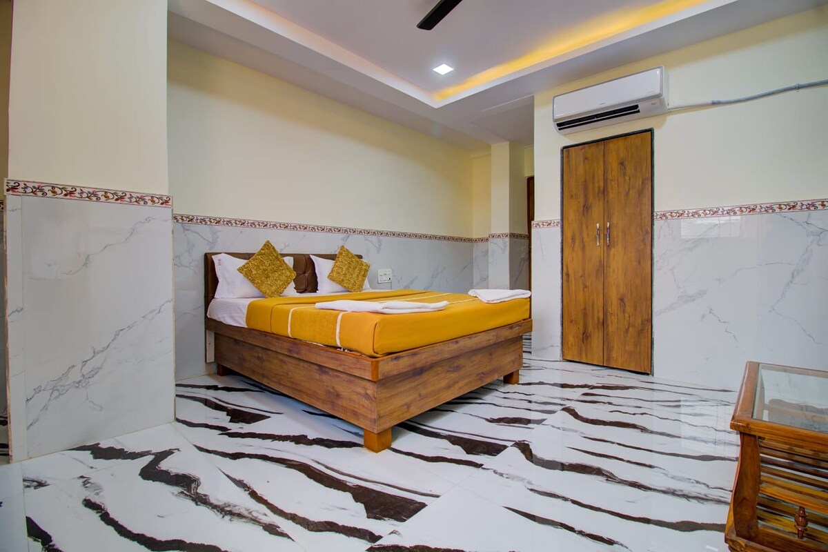 A bedroom with a wooden bed, marble walls, and a zebra-patterned floor.