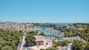 A coastal cityscape with a marina, buildings, and a prominent 'MAJORCA' sign.